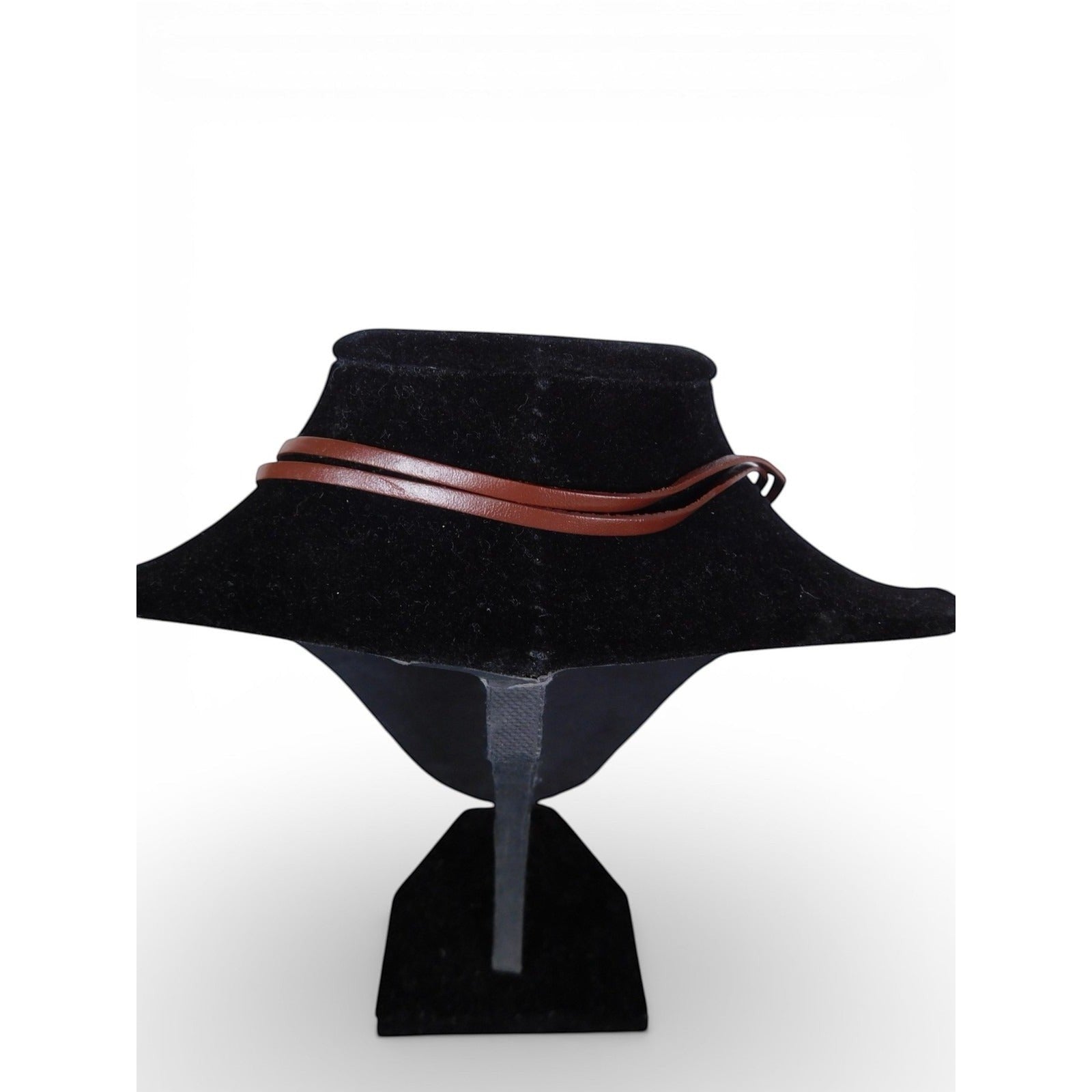 The Witches' Quest brown leather cord necklace on a black display bust, featuring a minimalist rustic design.