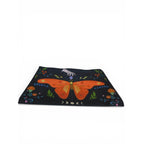 The Witches' Quest canvas clutch featuring a vibrant orange butterfly, celestial moon phases, and floral motifs.