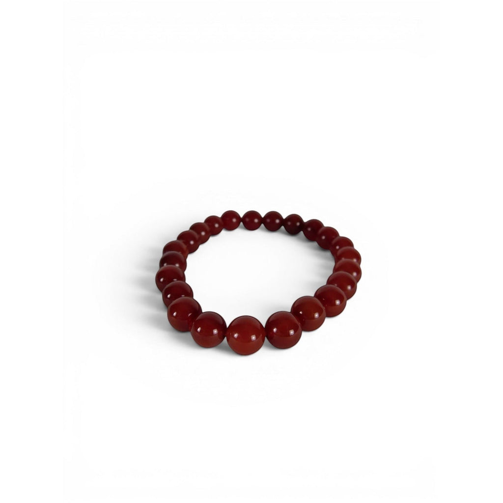 The Witches' Quest 8mm natural carnelian beaded stretch bracelet with polished orange-red gemstone beads.