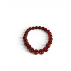 The Witches' Quest natural carnelian beaded bracelet with 8mm polished red gemstones on an elastic stretch band.