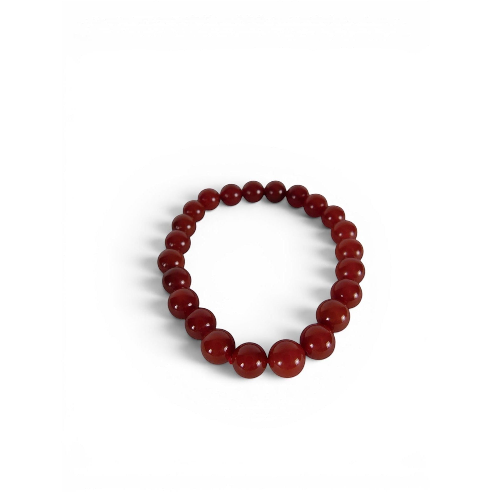 The Witches' Quest natural carnelian beaded bracelet with 8mm polished red gemstones on an elastic stretch band.