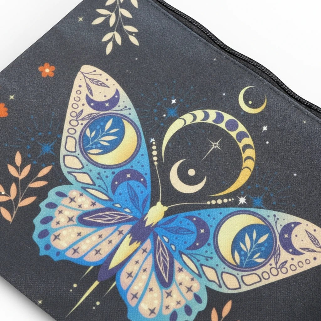 The Witches' Quest small black zip clutch featuring a celestial butterfly print with moons, stars, and floral motifs.