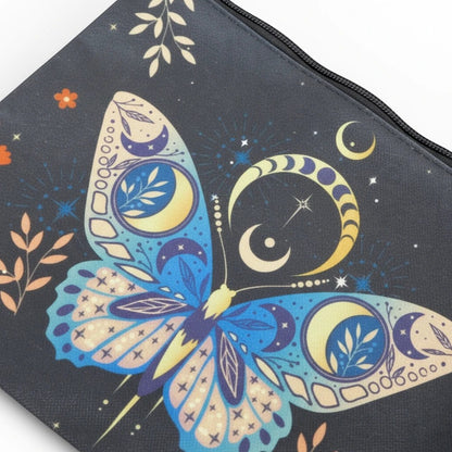 The Witches' Quest small black zip clutch featuring a celestial butterfly print with moons, stars, and floral motifs.