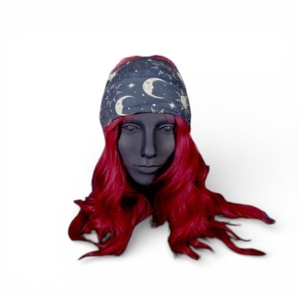 The Witches' Quest celestial moon and star print stretchy headband on a mannequin with vibrant red hair