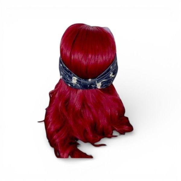 The Witches' Quest celestial moon and star print stretchy fabric headband worn on a mannequin with red hair