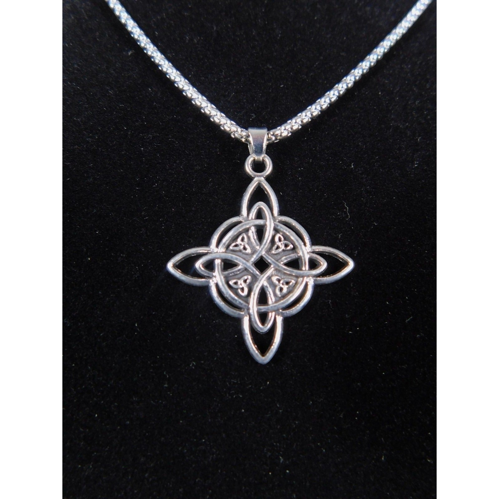 The Witches' Quest silver tone Celtic knot pendant necklace with an intricate openwork design on a box chain.