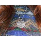 The Witches' Quest silver-tone Celtic Tree of Life pendant necklace worn on a patterned sweater