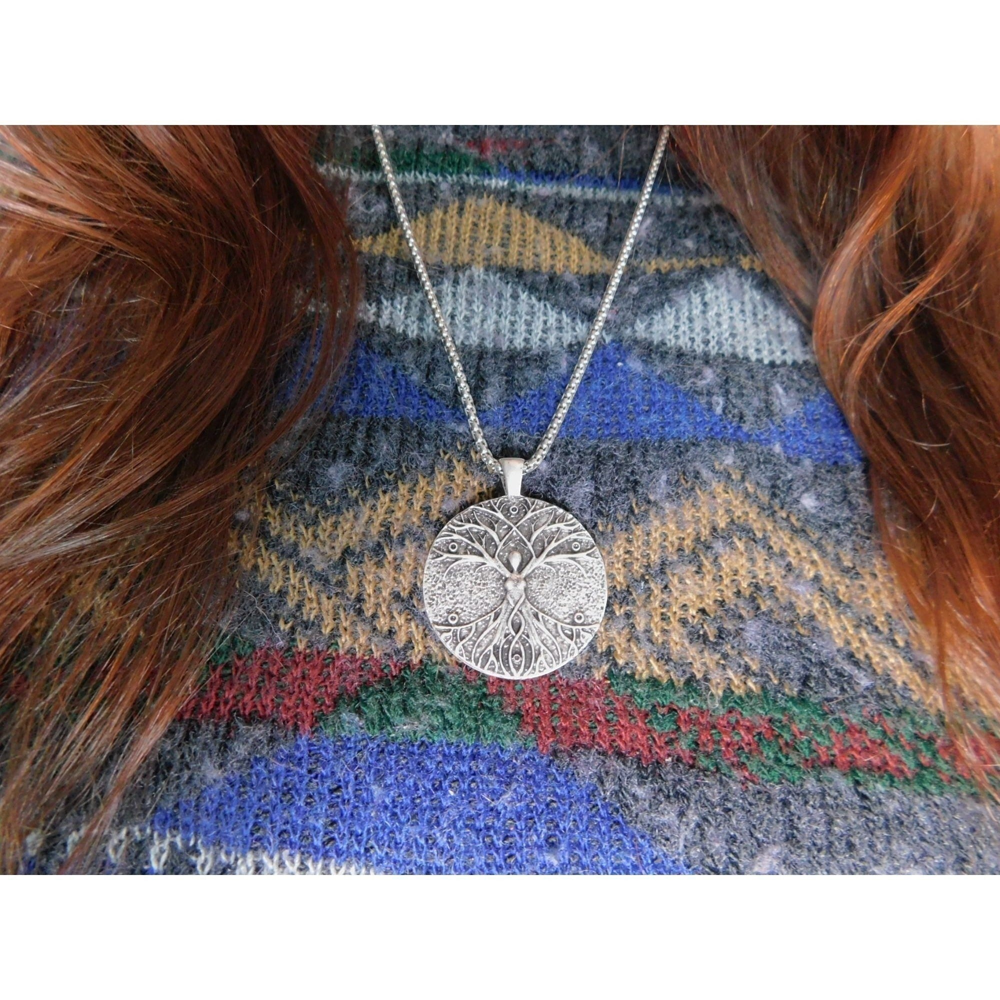 The Witches' Quest silver-tone Celtic Tree of Life pendant necklace worn on a patterned sweater