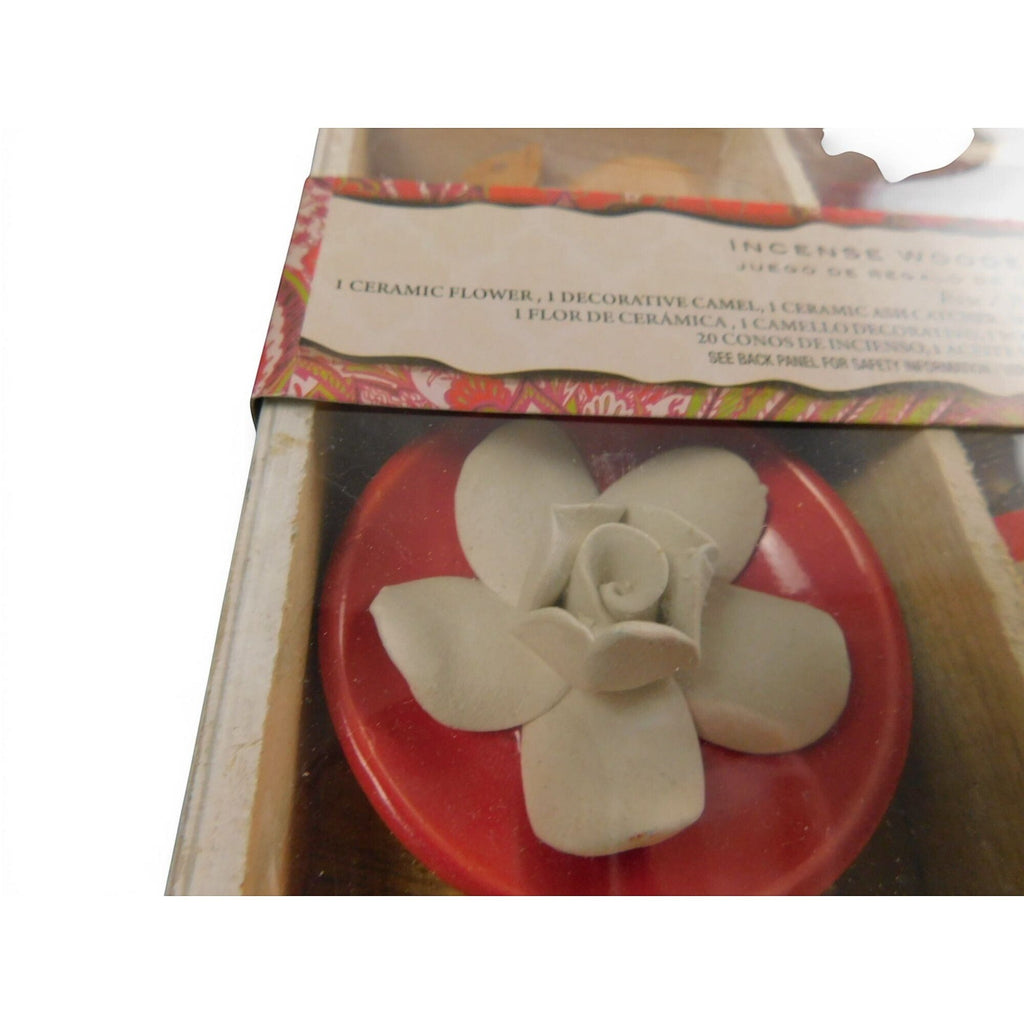 The Witches' Quest incense gift set featuring a white ceramic flower ash catcher inside a wooden box.