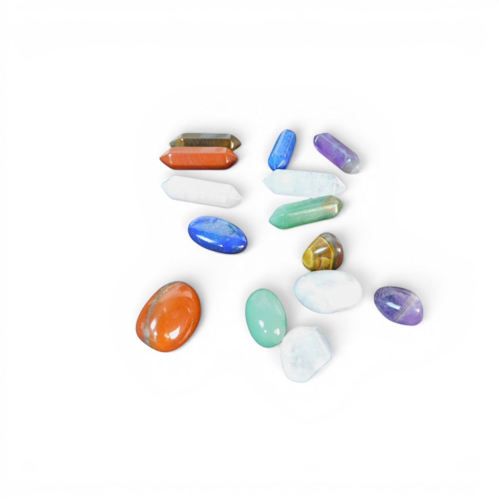 The Witches' Quest 14-piece chakra crystal set featuring assorted polished hexagonal columns and tumbled gemstones.