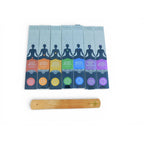The Witches' Quest 7 chakra incense set with 140 sticks in color-coded boxes and a wooden incense burner.