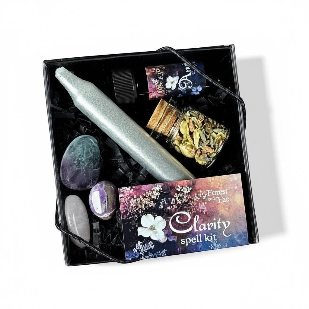 The Witches' Quest Forest and Fae clarity spell kit with ritual candle, herbs, anointing oil, and crystals in a box.