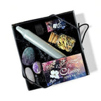 The Witches' Quest Forest and Fae Clarity Spell Kit featuring a ritual candle, botanical herbs, oil, and crystals.