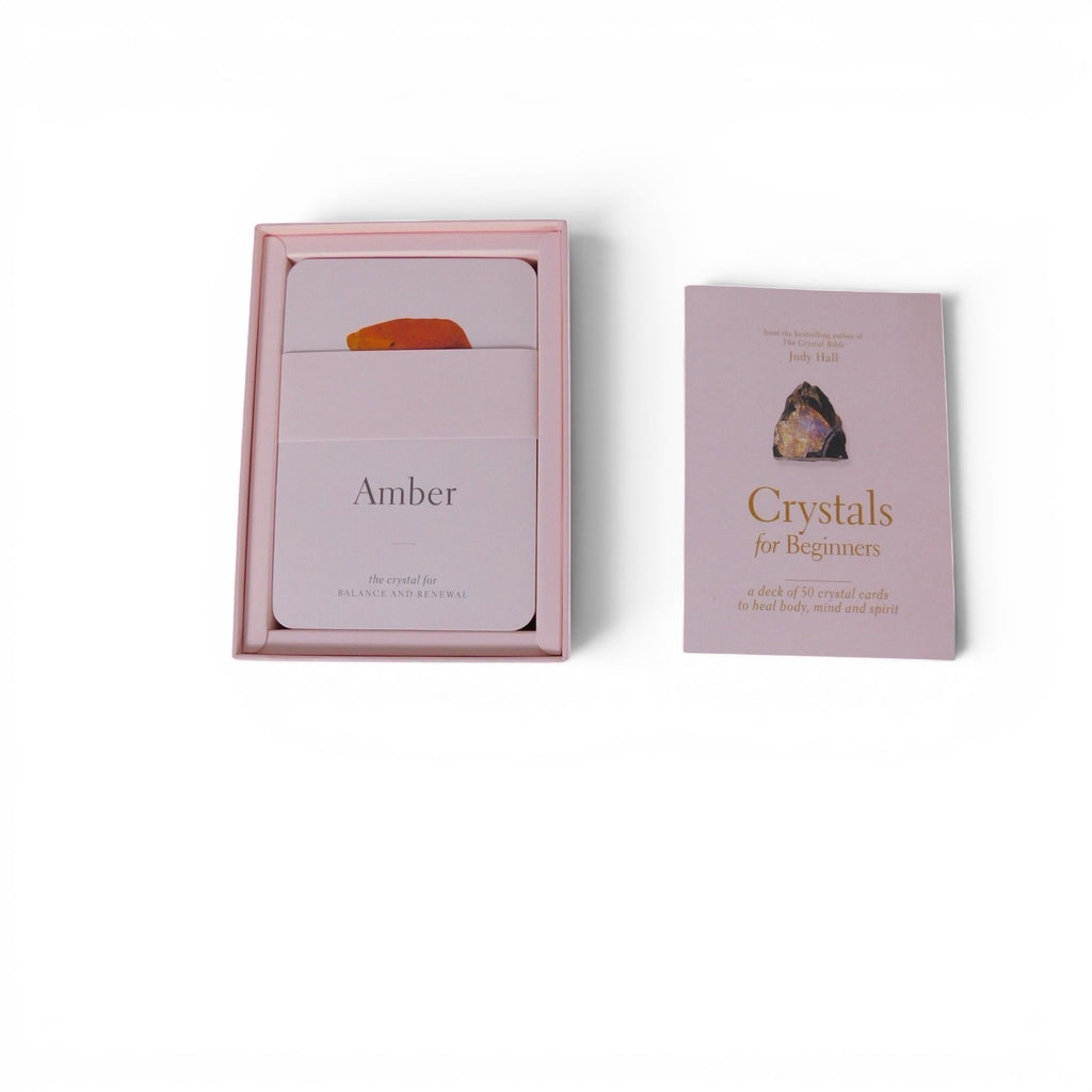 The Witches' Quest Crystals for Beginners deck of 50 instructional cards in a soft pink box with a guide booklet.