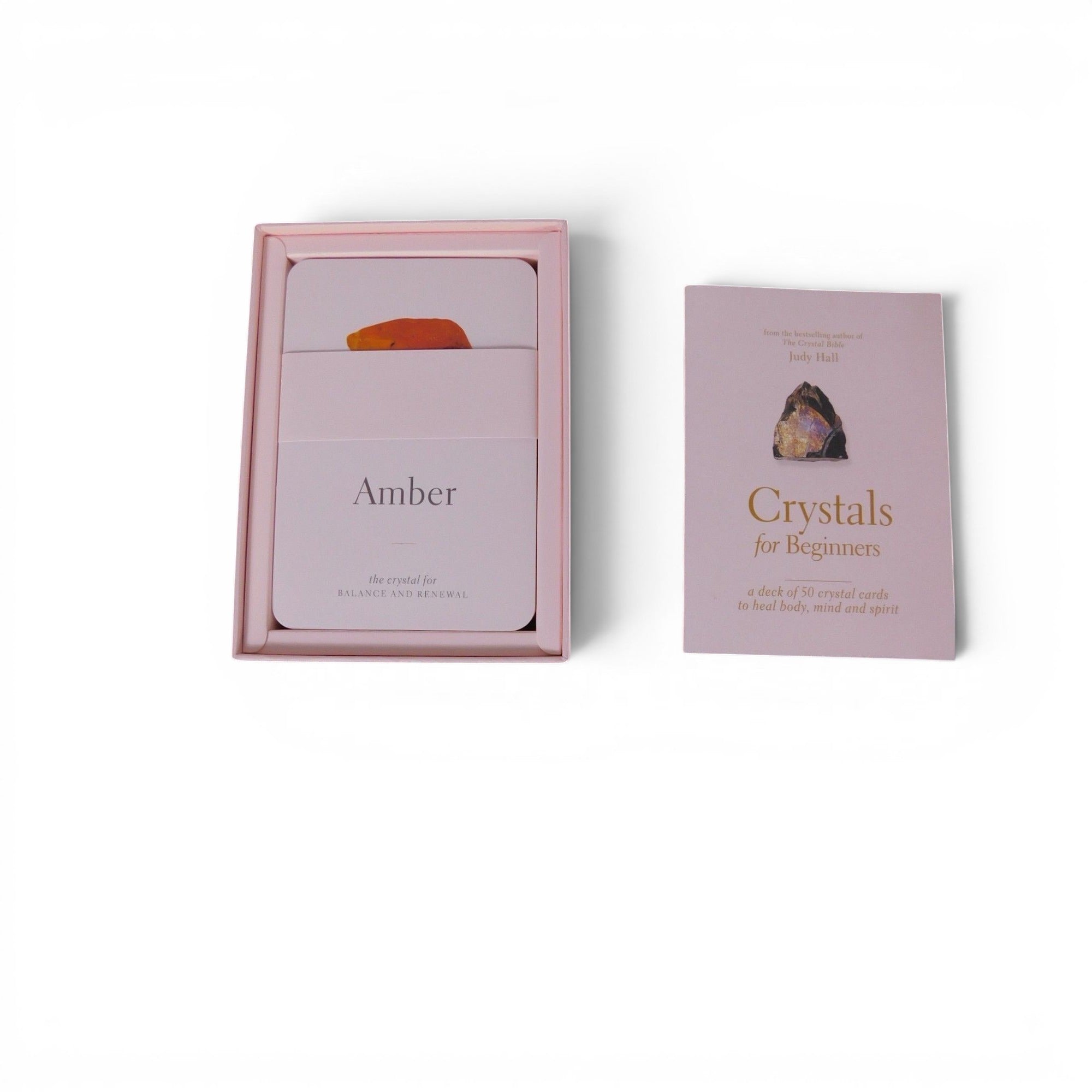 The Witches' Quest Crystals for Beginners deck of 50 instructional cards in a soft pink box with a guide booklet.