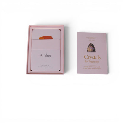 The Witches' Quest Crystals for Beginners deck of 50 instructional cards in a soft pink box with a guide booklet.