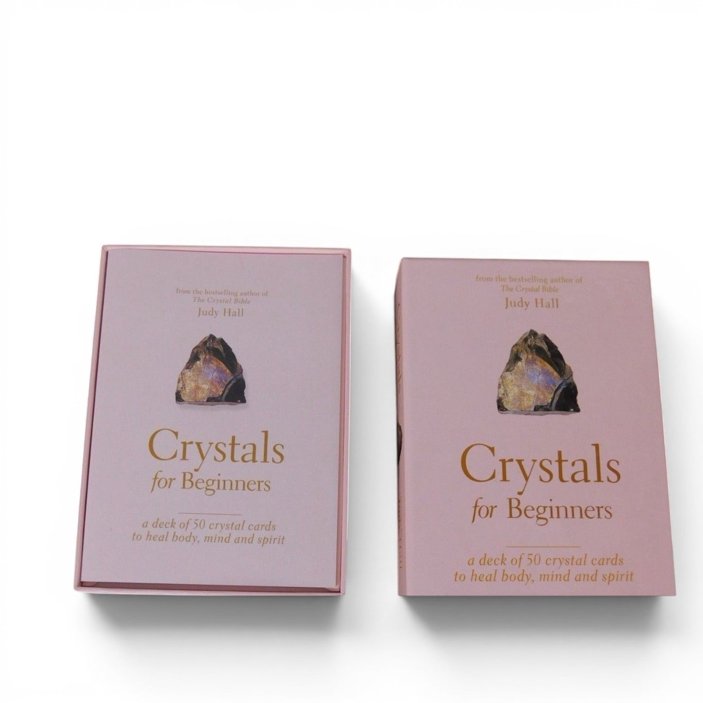 The Witches' Quest Crystals for Beginners deck of 50 instructional cards in a soft pink storage box by Judy Hall.