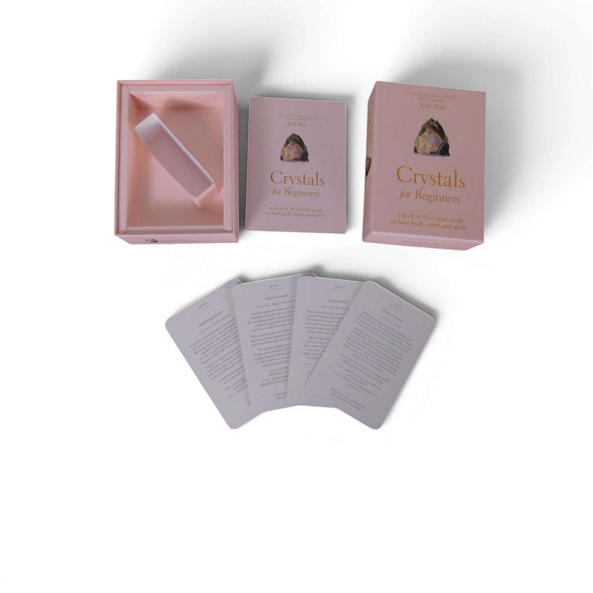 The Witches' Quest Crystals for Beginners deck with 50 instructional cards and a soft-pink storage box.