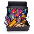 The Witches' Quest Day of the Dead altar box featuring a rainbow Santa Muerte statue, oracle deck, and skull decanter.