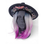 The Witches' Quest black wide brim fedora with colorful butterfly, floral, and moon phase embroidery on a mannequin.