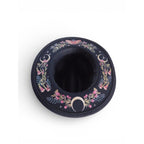 The Witches' Quest black wide brim fedora with colorful floral, moon phase, and butterfly embroidery on the brim