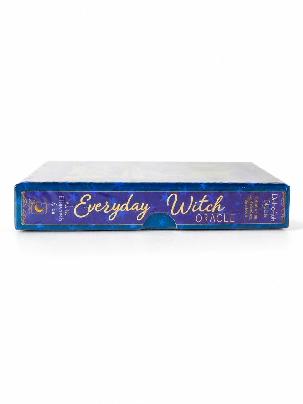 The Witches' Quest Everyday Witch Oracle deck box side view featuring blue starry design and gold lettering