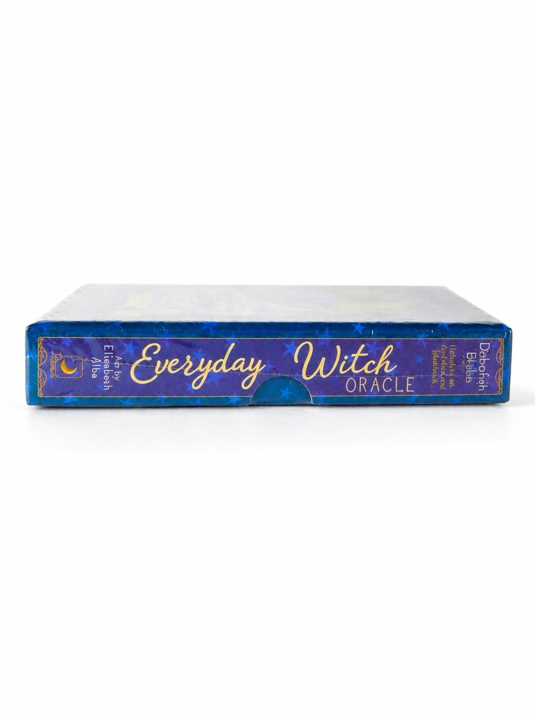 The Witches' Quest Everyday Witch Oracle deck box side view featuring blue starry design and gold lettering