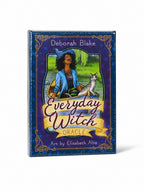 The Witches' Quest Everyday Witch Oracle deck box featuring whimsical art of a woman in a boat with a cat.