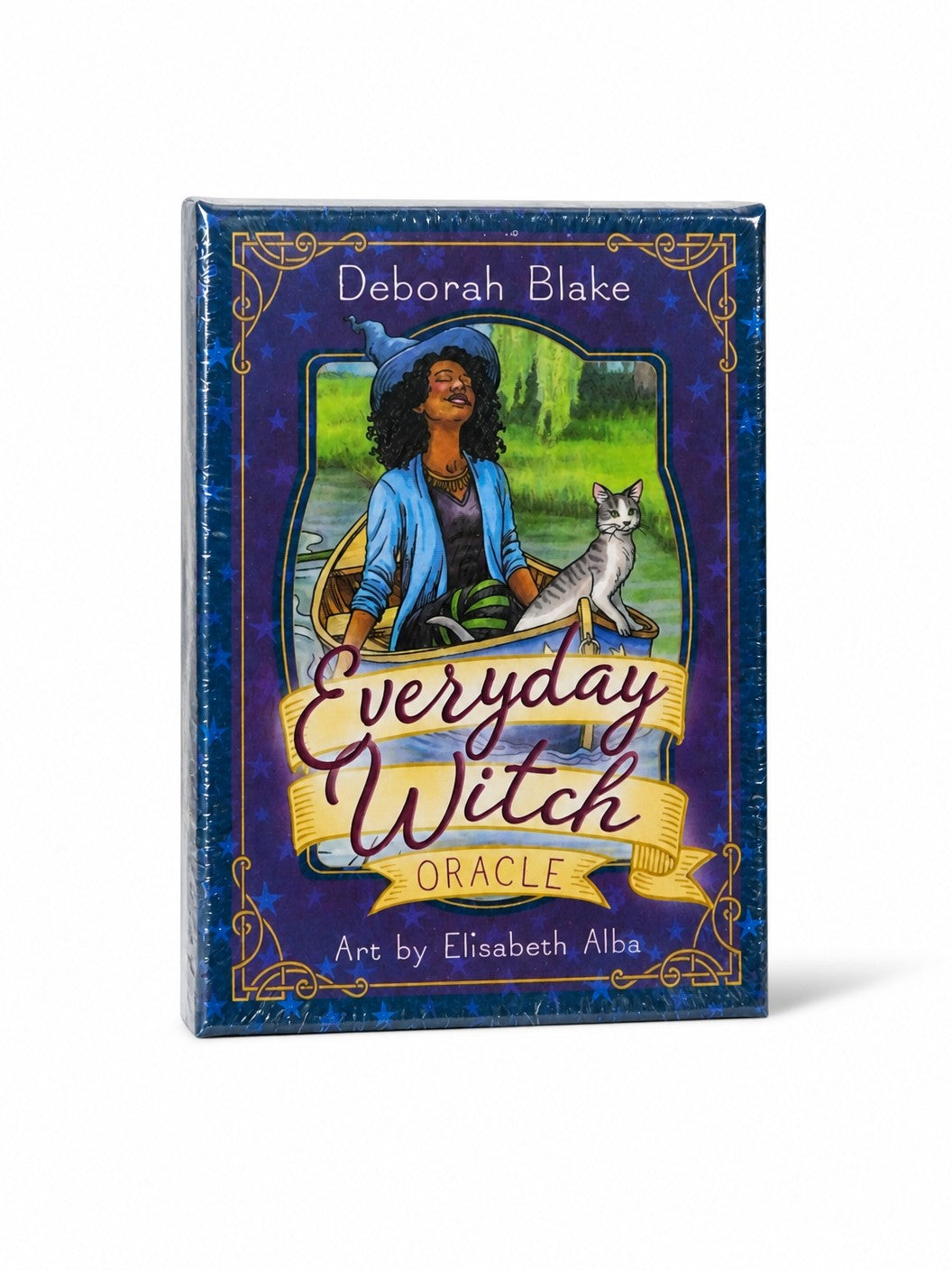 The Witches' Quest Everyday Witch Oracle deck box featuring whimsical art of a woman in a boat with a cat.