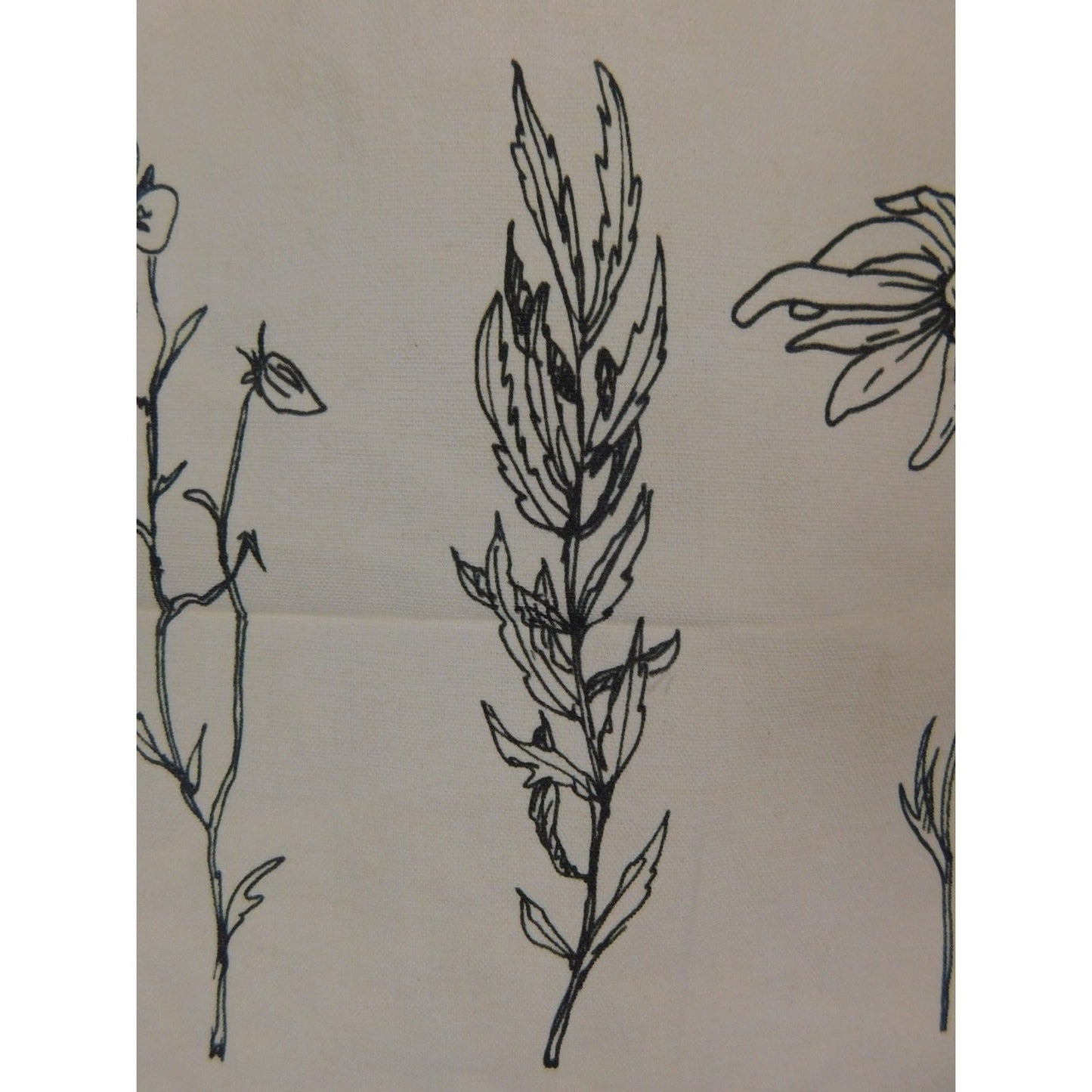 The Witches' Quest beige canvas tote bag featuring detailed black line art of three botanical flowers