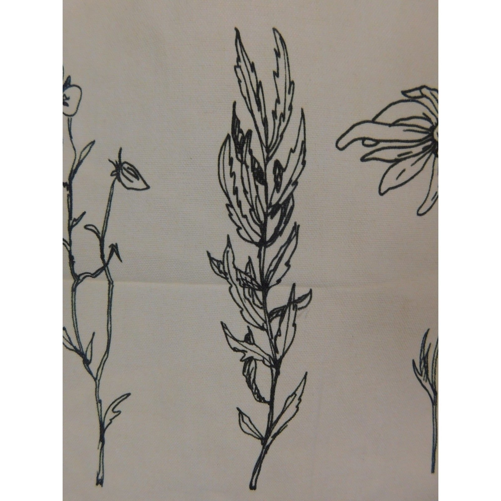 The Witches' Quest beige canvas tote bag featuring detailed black line art of three botanical flowers