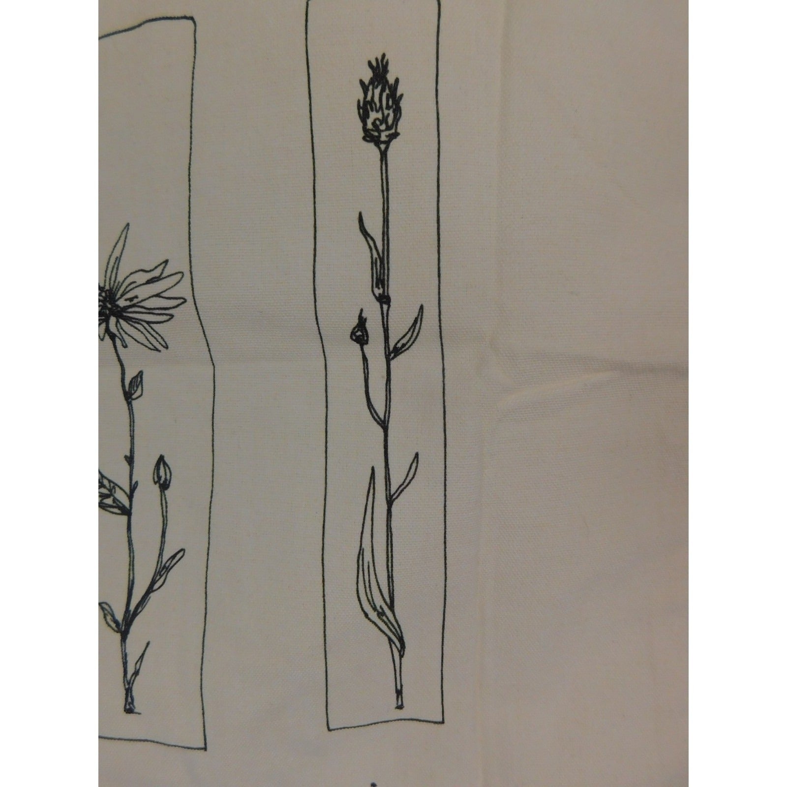 The Witches' Quest beige canvas tote bag featuring black floral line art in rectangular panels.