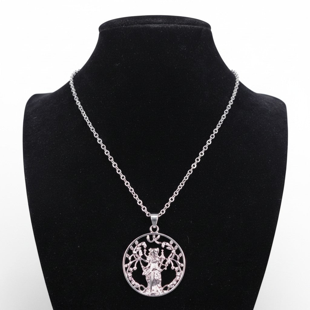 The Witches' Quest silver-tone goddess tree of life pendant necklace on a black display bust