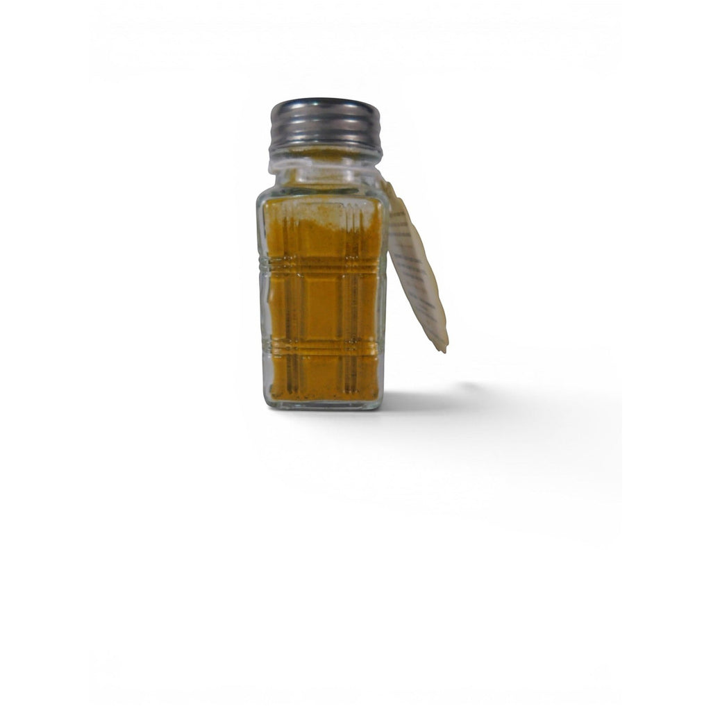 The Witches' Quest Gold Dust money spell refresher in a clear glass shaker bottle with a metal lid and hanging label.