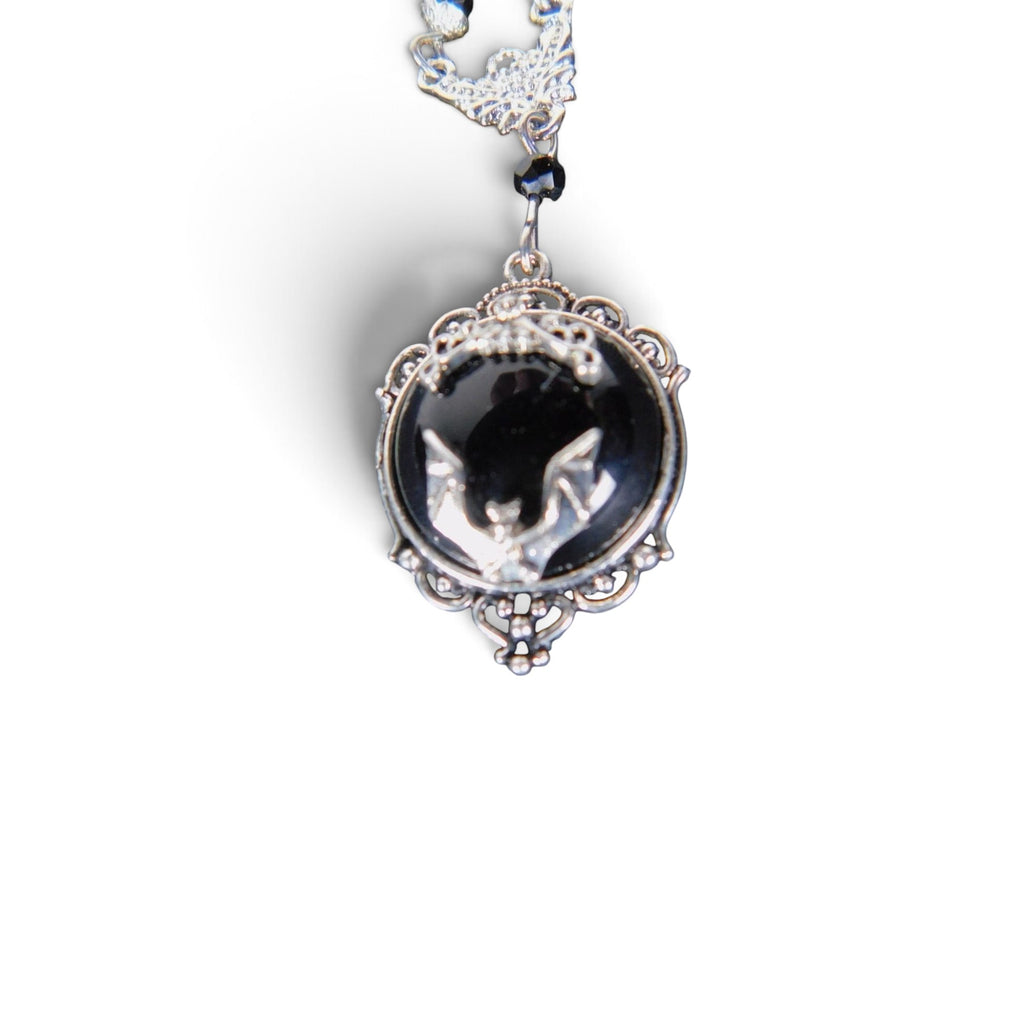 The Witches' Quest Victorian gothic necklace with a silver bat cameo on a black resin background in an ornate frame.
