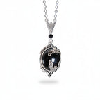 The Witches' Quest gothic bat cameo necklace featuring a silver bat on a black resin oval with ornate scrollwork frame.