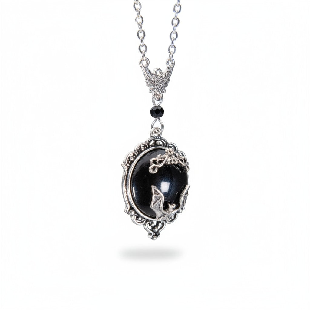 The Witches' Quest gothic bat cameo necklace featuring a silver bat on a black resin oval with ornate scrollwork frame.