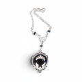 The Witches' Quest gothic bat cameo necklace in silver-tone alloy with a black resin backdrop and ornate scrollwork.