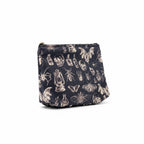 The Witches' Quest gothic makeup bag in black fabric with a white skull, insect, and lantern print and zipper closure.