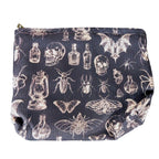 The Witches' Quest gothic makeup bag in black fabric with a white skull, insect, and potion bottle print.