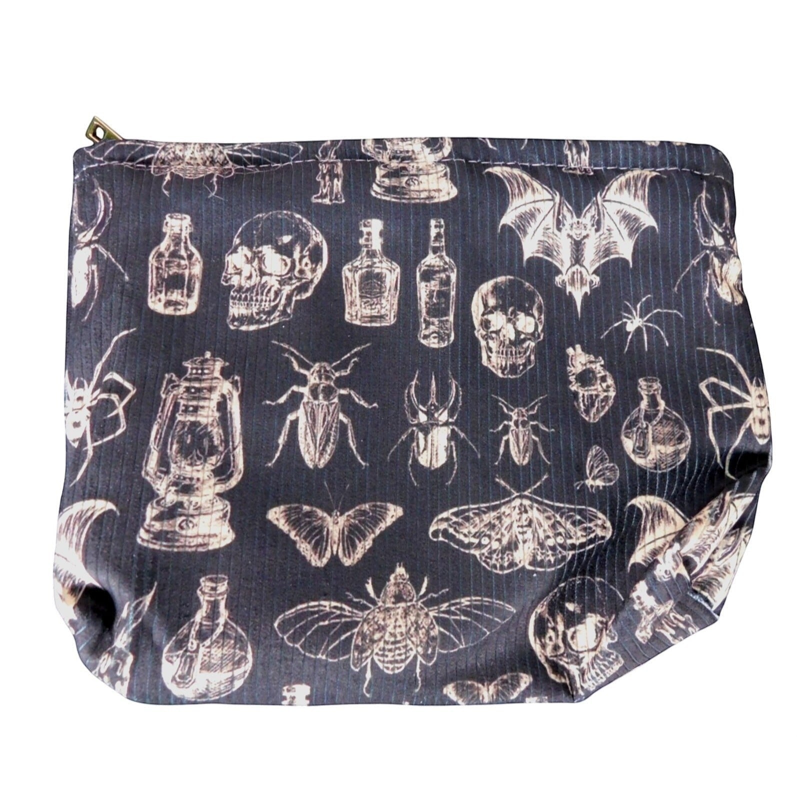 The Witches' Quest gothic makeup bag in black fabric with a white skull, insect, and potion bottle print.