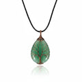 The Witches' Quest green aventurine teardrop pendant with copper wire wrapped tree of life design on a black cord.