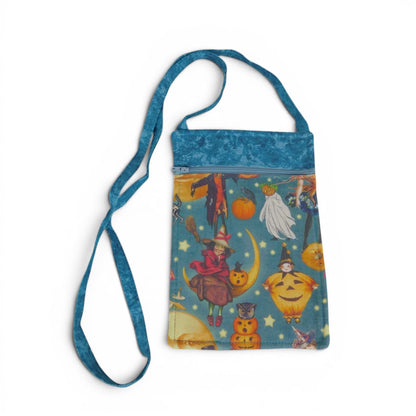 The Witches' Quest handmade blue crossbody bag with vintage witch and pumpkin Halloween print and adjustable strap.