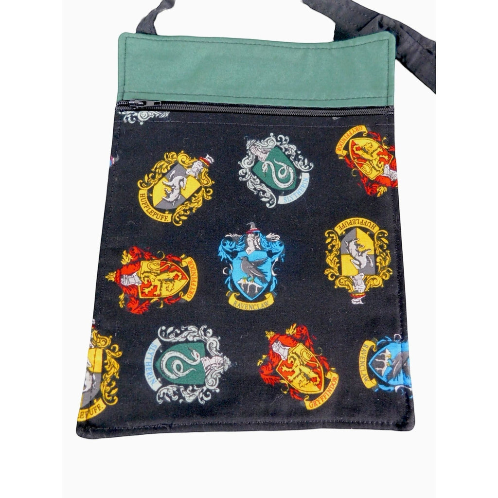 The Witches' Quest handcrafted Harry Potter crossbody bag with black fabric featuring colorful Hogwarts house crests.