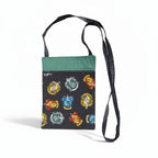 The Witches' Quest handcrafted Harry Potter crossbody bag with vibrant house crests and a green top trim.