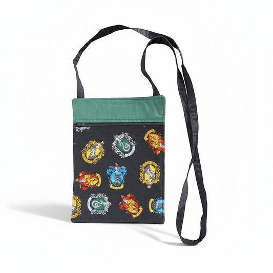 The Witches' Quest handcrafted Harry Potter crossbody bag with vibrant house crests and a green top trim.