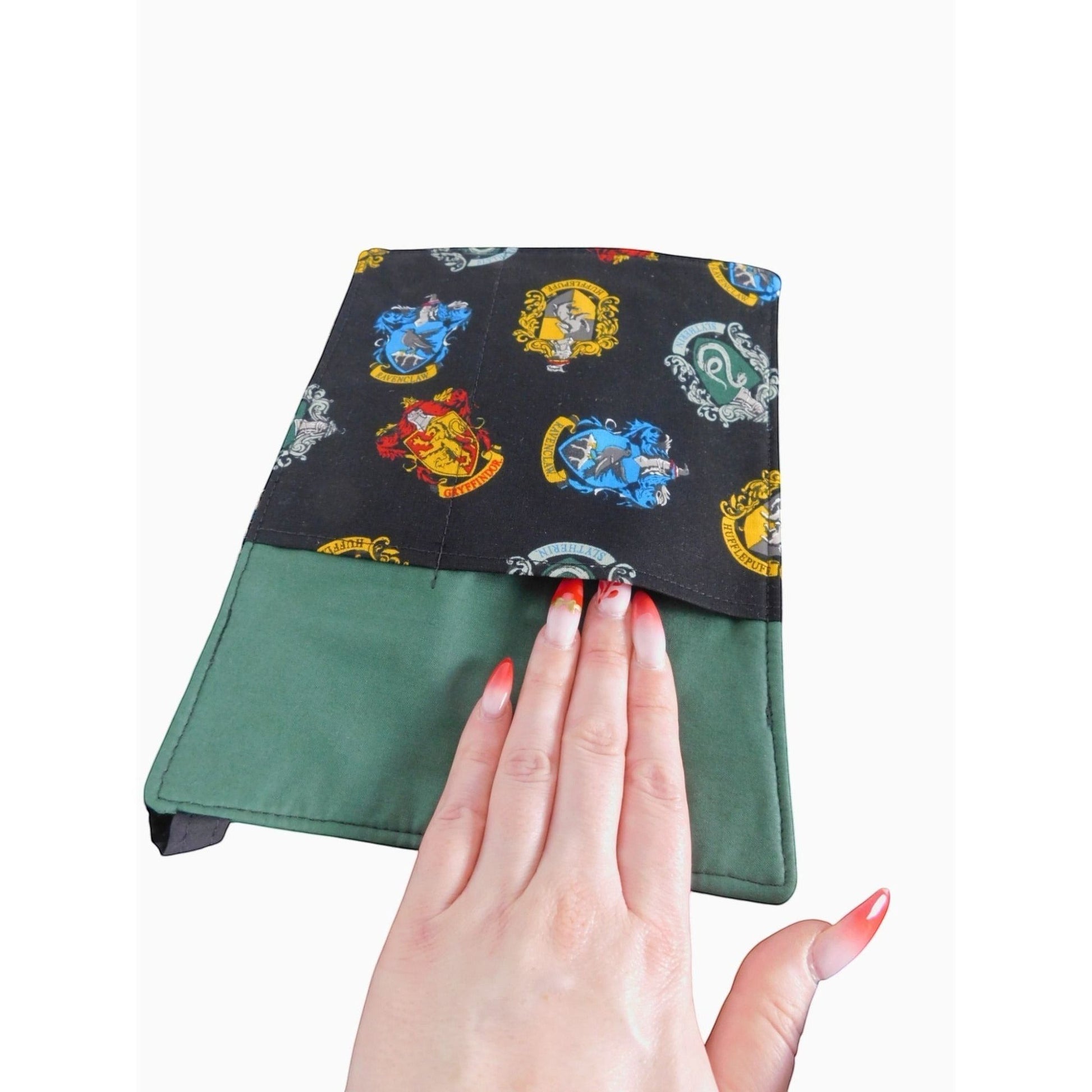 The Witches' Quest handcrafted Harry Potter crossbody bag with vibrant house crests on black and green fabric.