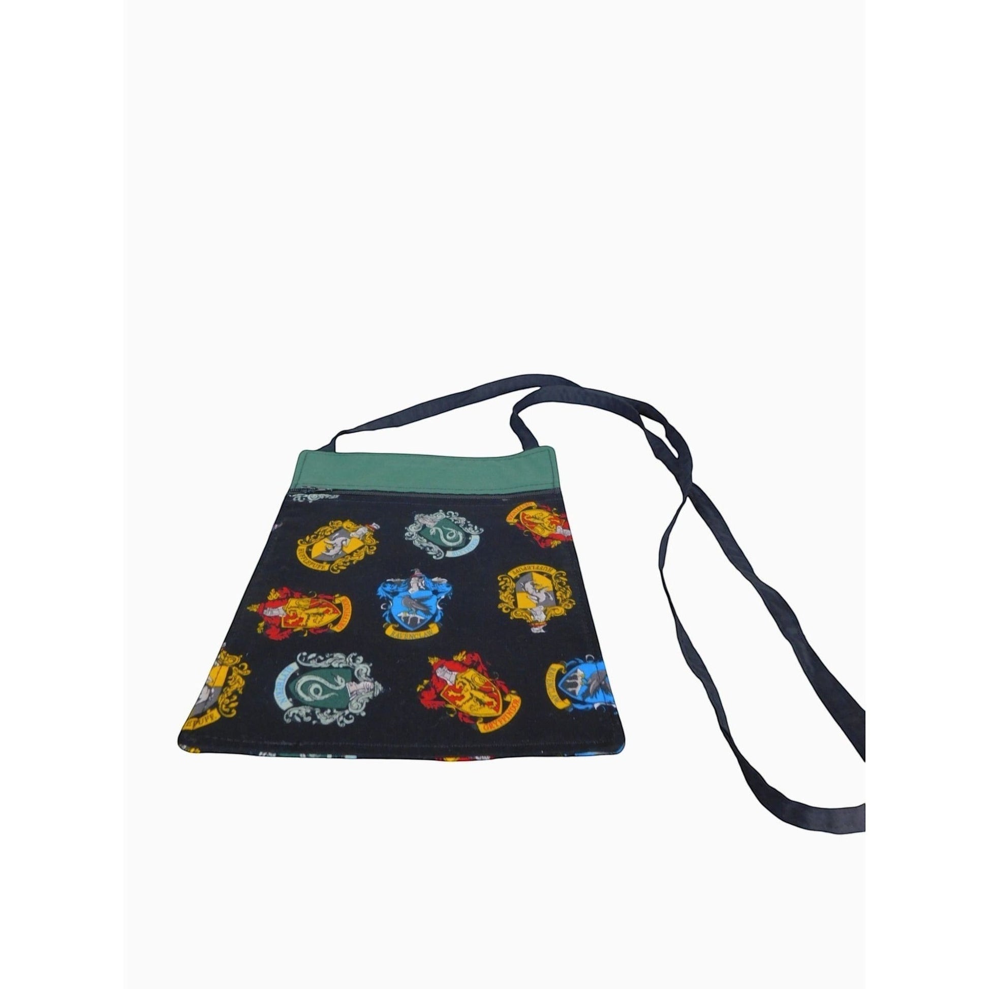 The Witches' Quest handcrafted Harry Potter crossbody bag featuring vibrant Hogwarts house crests on a black fabric.