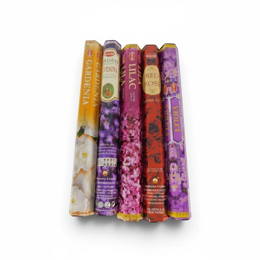 The Witches' Quest HEM floral incense variety pack featuring five hexagonal boxes of gardenia, lavender, lilac, rose, and violet scents.