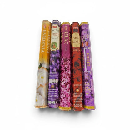 The Witches' Quest HEM floral incense variety pack featuring five hexagonal boxes of gardenia, lavender, lilac, rose, and violet scents.